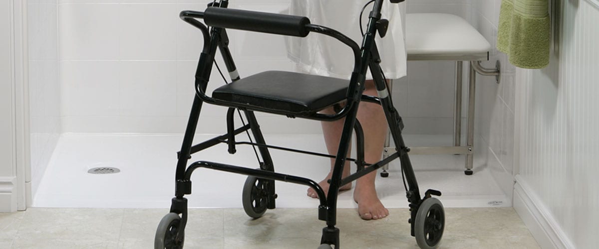 woman using walker to exit a curbless shower
