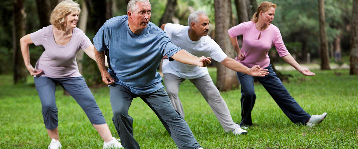 seniors doing tai chi in the park