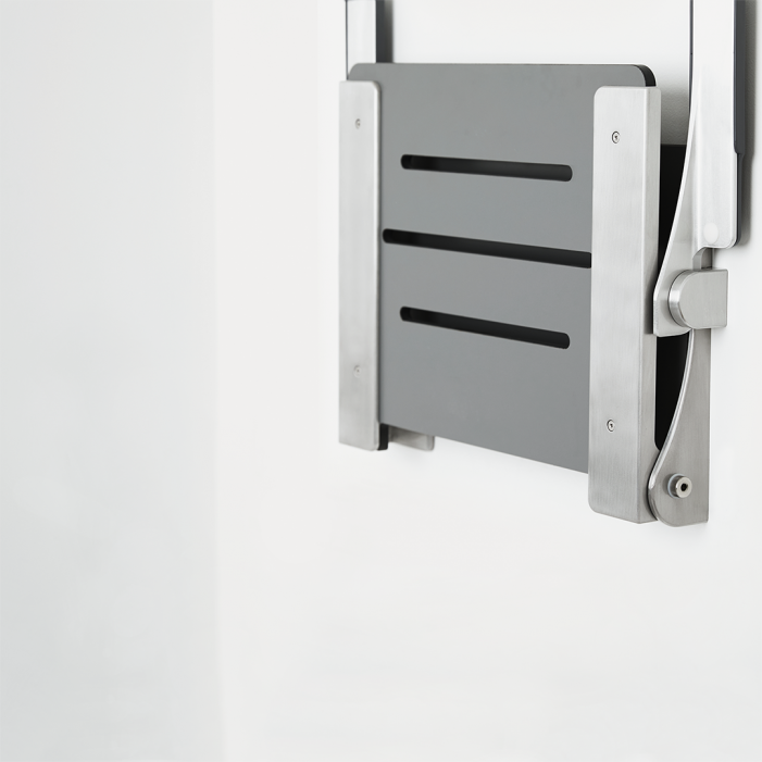 Gray wall mounted shower seat with back and arms folded up