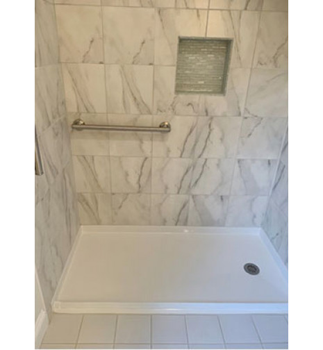 Freedom 60 by 36 shower pan installed with marble tiles walls and grab bar