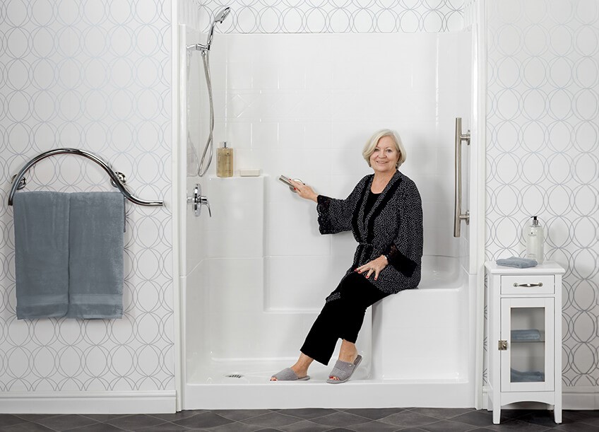 Walk in Shower stall from Freedom Showers with elderly woman sitting