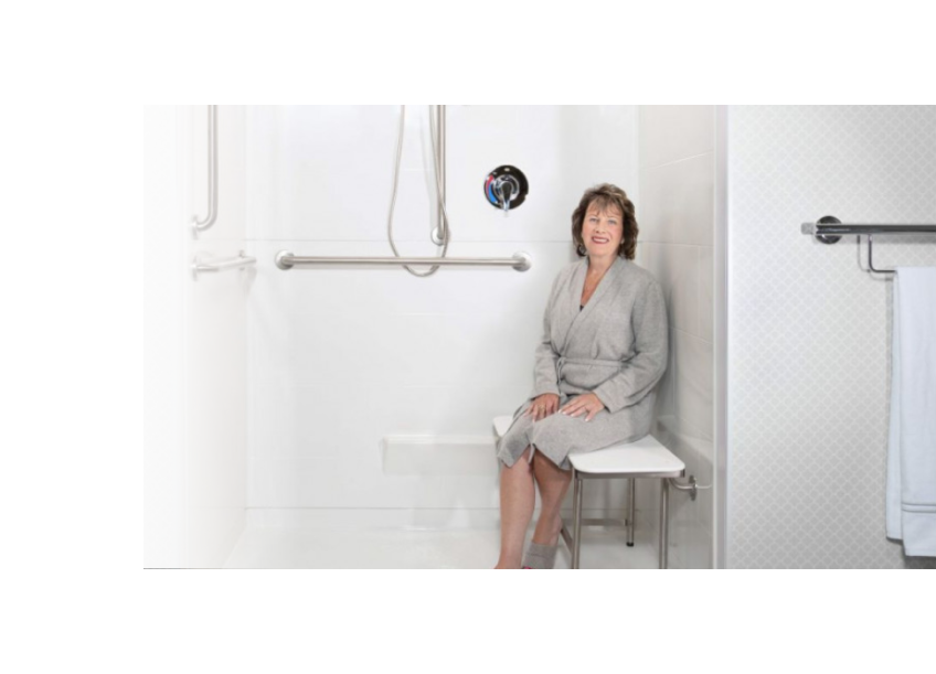 Woman sitting on an ADA shower seat with legs