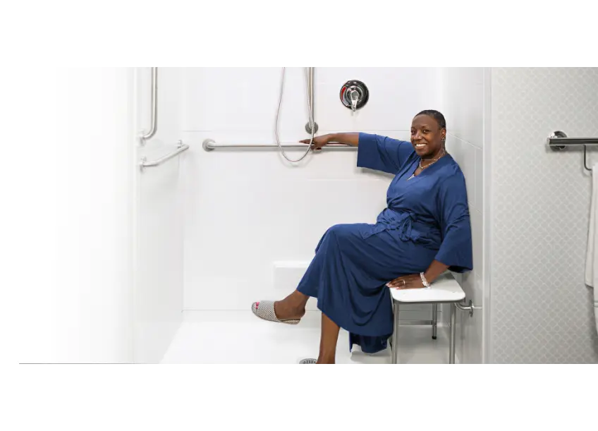 Woman in a Roll in Accessible Shower stall in her home with a Barrier Free threshold