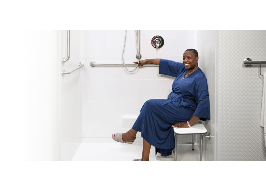Woman in a Roll in Accessible Shower stall in her home with a Barrier Free threshold