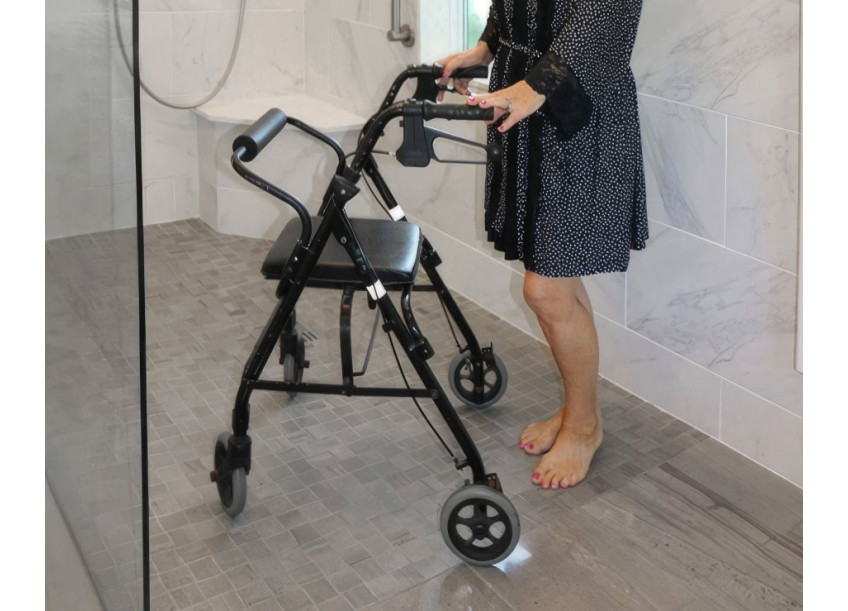 Senior woman in a level access tiled shower pan