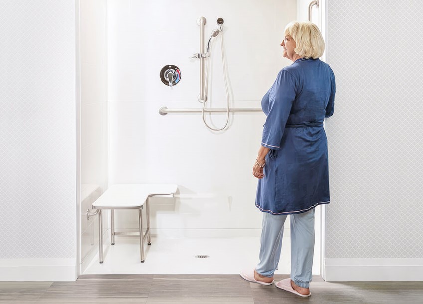 Woman stepping into Accessible, ADA, or Walk in Shower Pan