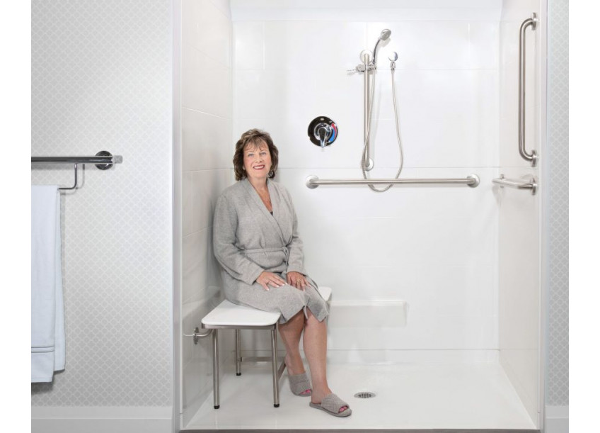 Woman sitting on an ADA shower seat with legs