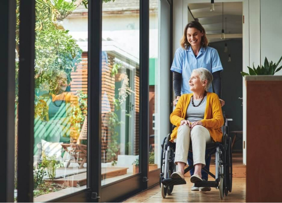 senior and assisted living facilities senior in wheelchair inside retirement home with nurse