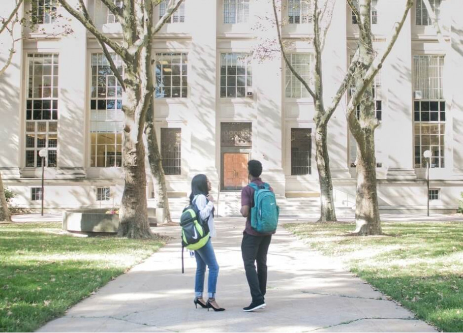 Freedom Showers for college dorms and student housing Students walking towards college dorms