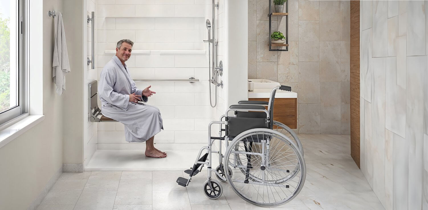 man sitting in roll in shower