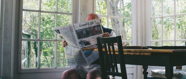 Senior man reading news paper